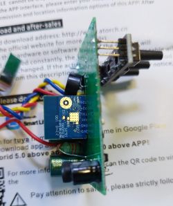 Close-up of an electronic module with visible components on a circuit board.