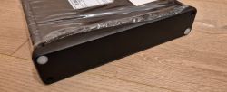 Plastic electronic device enclosure in protective film.
