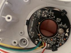 Close-up of a circuit board with wires inside a plastic casing.