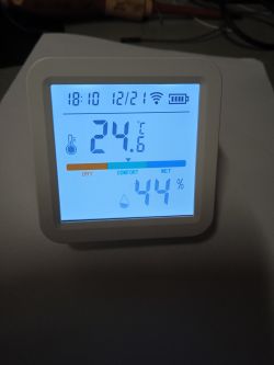 Digital display showing temperature and humidity.