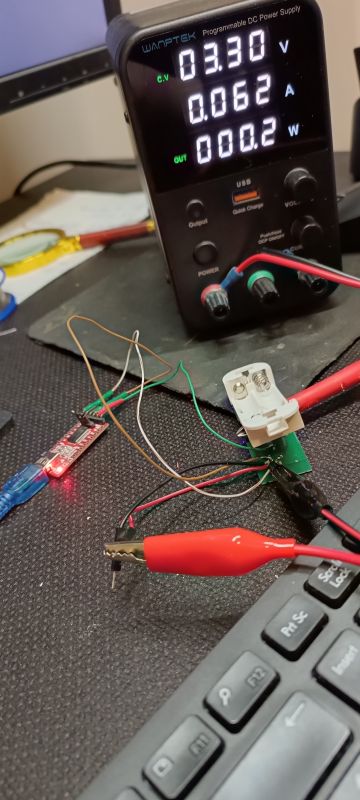 Programmable DC power supply connected to an electronic circuit on a desk.