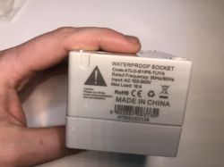 Close-up of the back side of the ATLO-S1IP5-TUYA waterproof socket housing with technical data and markings.