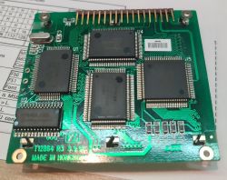 Green PCB with several IC chips and a gold pin header connector along the top edge.