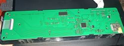 Green PCB with ICs and connectors mounted in a black device housing