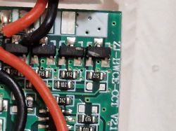 Close-up of damaged printed circuit board with SMD components and wires