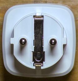 Top view of a Tuya smart plug showing its electrical pins.