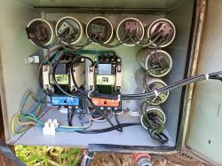 Control cabinet with electrical components and wires.