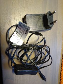AC adapter with European plug and CALEx label attached to the cable