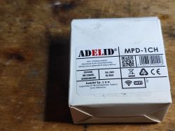 Adelid MPD-1CH relay box on wooden surface, product label clearly visible