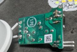 Electronic Module with Visible Connections Close-up of an electronic module with visible pins and prints on a green board.