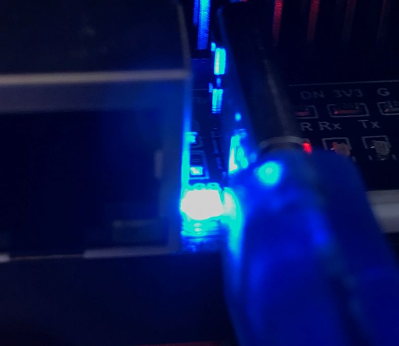 USB cable and blue LED indicators on labeled circuit board Close-up of USB cable and blue LEDs on an electronic board with labeled connections