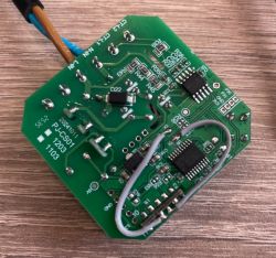 Green PCB with wires, microchips, and printed technical markings