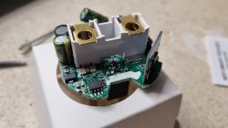 Close-up of an electronic module with PCB and relay.