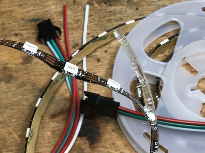 LED Strip WS2812B with Wires LED strip WS2812B with visible wires on a wooden surface.