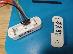 Plastic casing with SHT30 sensor and colored wires.