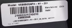 White label with barcode and model number VES650QNFH-N1-201 on a black device surface.