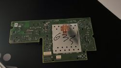 Green circuit board with metal shield and handwritten 633 in marker