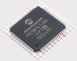 Microchip PIC18F67J60 Microcontroller Microchip PIC18F67J60 microcontroller on a measurement grid background