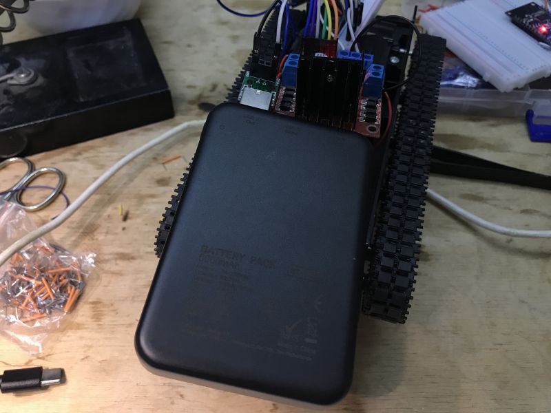 Tracked Robot with NodeMCU and L298 Powered by Power Bank Tracked vehicle with electronic components and a power bank.