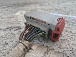 Close-up of a car electrical plug with multiple colored wires.