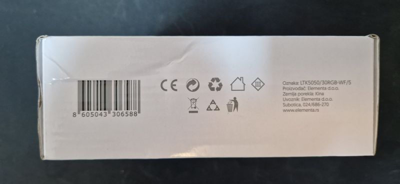 White box with markings and a barcode on the side.