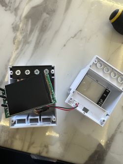 Open white electronic box with components inside.