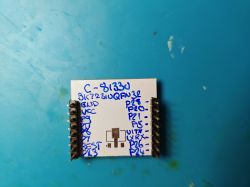C-8133U module with port labels soldered onto an ESP-12E board on a blue background.