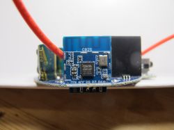 Electronic Module with PCB Electronic module with a blue PCB and connected red wire.