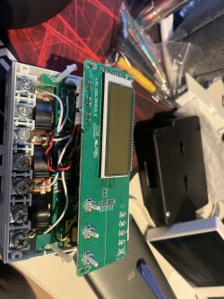 Image of the interior of an electronic device with a circuit board and LCD screen.