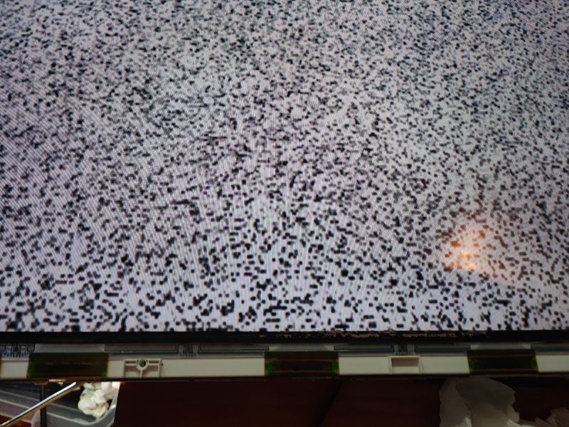 TV Screen with Disturbances after Flood Damage Close-up of a TV screen with static and artifacts.