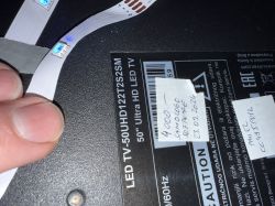 Service notes and model label on the back of a Vivax LED TV 50UHD122T2S2SM
