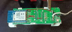 Close-up of a printed circuit board with an electronic module and wires.
