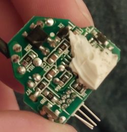 Close-up of a green circuit board with electronic components.