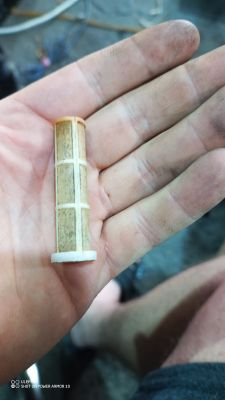 Dirty water filter from a Karcher pressure washer held in an open hand.