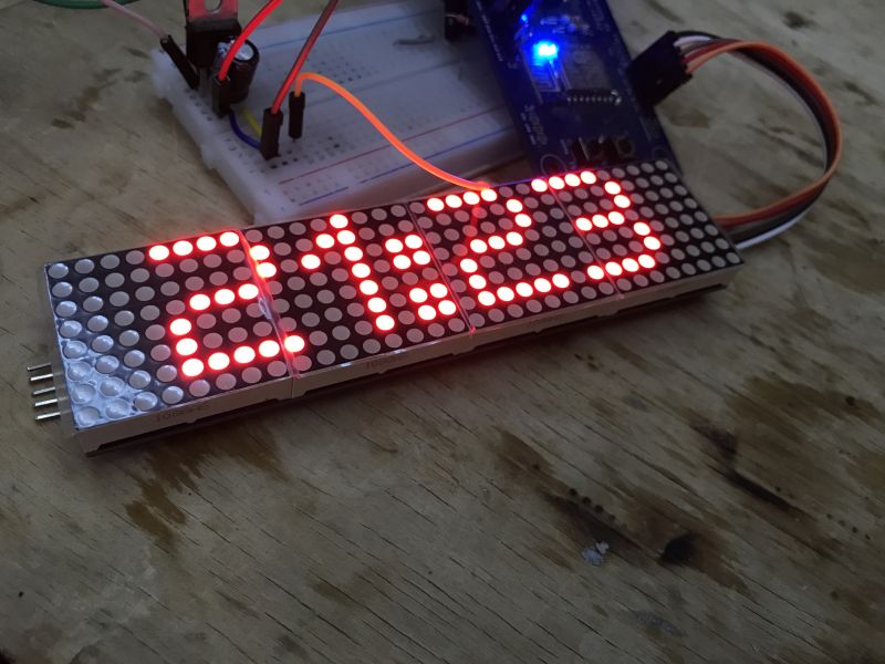 LED Display with Clock on Prototyping Breadboard LED display showing the time 21:23 on a prototyping breadboard.