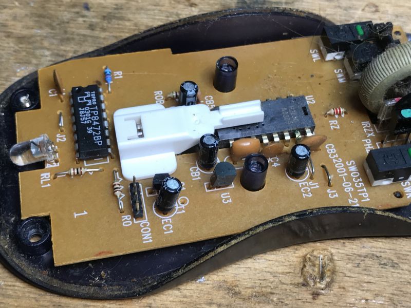 Internal Structure of an Old Computer Mouse Interior of an old computer mouse with visible circuit board and electronic components.