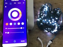 App for Controlling Colorful LED Lights App with color selection screen and white LED lights on a table