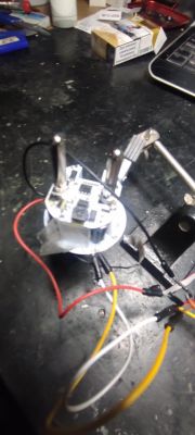 Close-up of a disassembled electronic circuit with wires on a desk.
