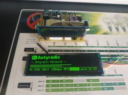 Two OLED displays, one larger and one smaller, connected to an ESP S3 UNO microcontroller on a table.