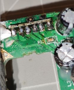 Circuit Board with Electronic Components Close-up of a circuit board with visible electronic components and signs of disassembly.