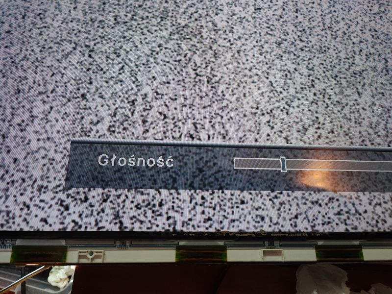 TV Screen with Static and Volume Adjustment TV screen displaying a volume adjustment bar against a background of static.