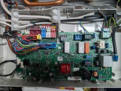 Control board of a gas boiler with visible electrical connections.