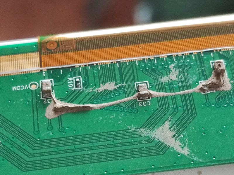 Television After Flood: Circuit Board Contamination Flood-damaged circuit board interior in a television.