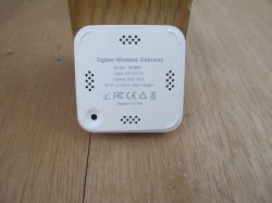 Zigbee wireless gateway placed on a wooden surface.