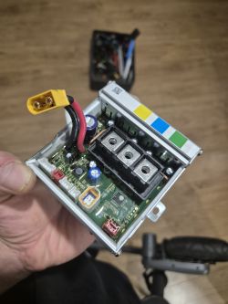 Zdjęcie sterownika hulajnogi z widocznymi przewodami i elementami elektronicznymi.