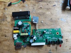 Circuit board from scrap with electronic components, including capacitors and a USB port.