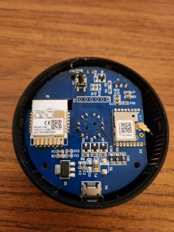 Interior of an electronic device with visible components on a printed circuit board.