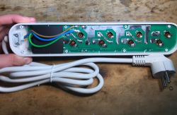 Inside of the Gembird TSL-PS-F4U-01-W power strip showing PCB, wiring, and attached power cord.