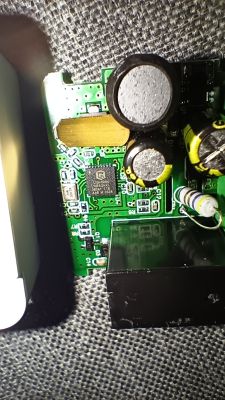 Close-up of PCB with capacitors, relay, and LNB82FKL microchip