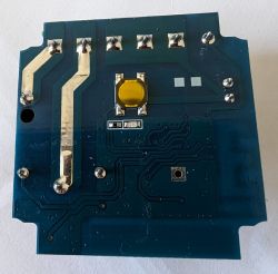 A printed circuit board with various traces, pads, and visible soldered components.